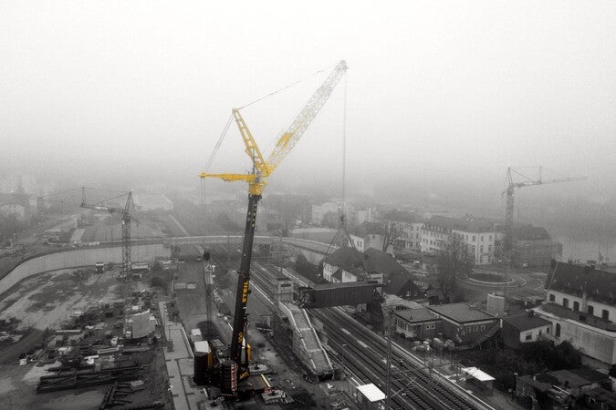 image by Johannes Schmidt containing crane, fog, city, build, building